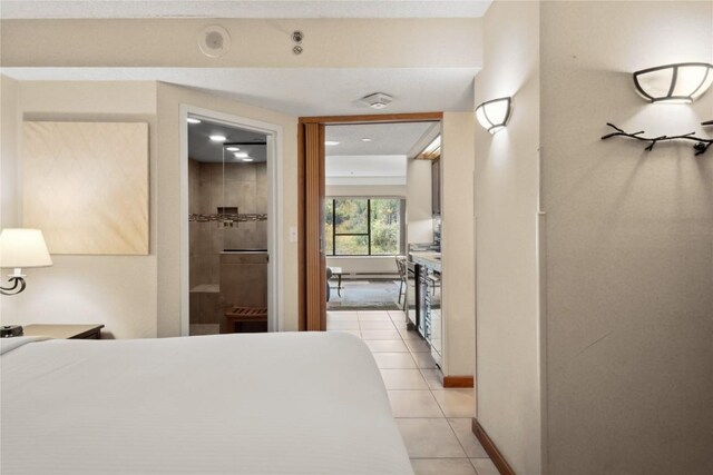 tiled bedroom featuring a closet and ensuite bath