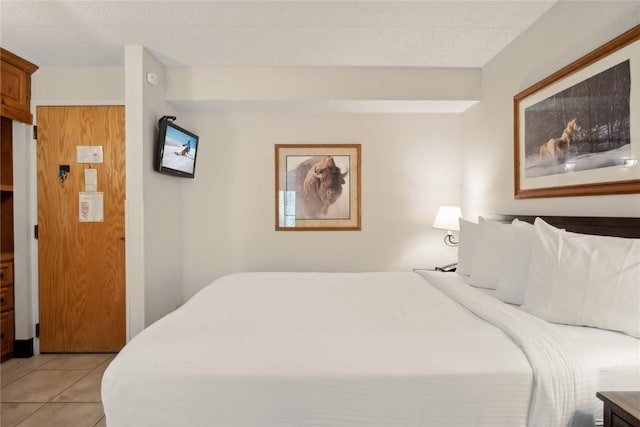 bedroom featuring light tile patterned flooring