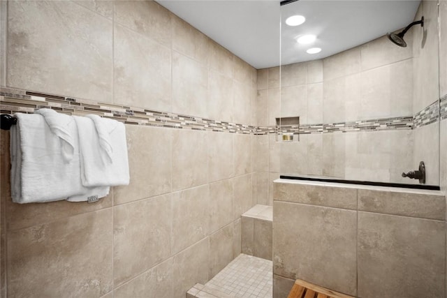 bathroom with tiled shower