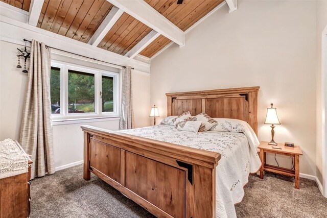 carpeted bedroom with vaulted ceiling with beams and wooden ceiling