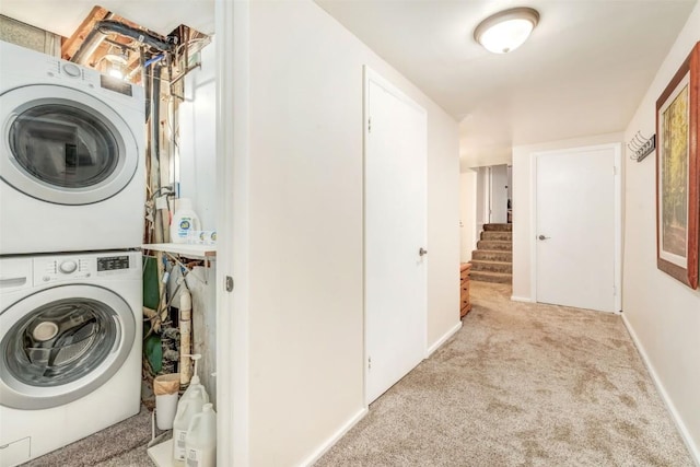 laundry room featuring light carpet and stacked washer and dryer