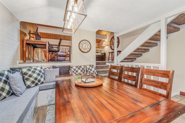 dining room featuring wood walls