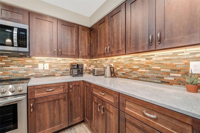 kitchen with tasteful backsplash and stainless steel appliances