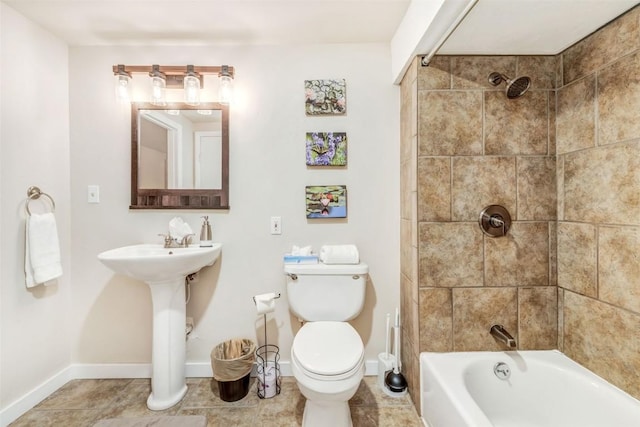 bathroom featuring toilet and tiled shower / bath