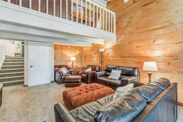 carpeted living room featuring a high ceiling