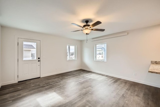 525 Castello Ave, Fairplay, CO 80440 - unfurnished room with baseboards, a ceiling fan, and dark wood-style floors