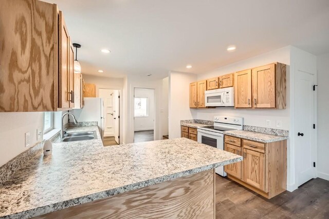 525 Castello Ave, Fairplay, CO 80440 - kitchen with a sink, white appliances, light countertops, a peninsula, and dark wood-type flooring