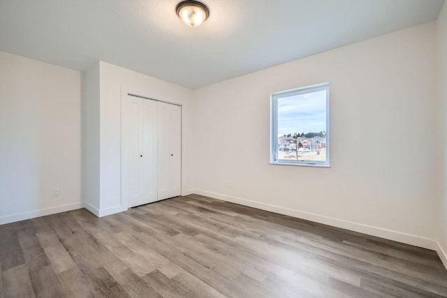 525 Castello Ave, Fairplay, CO 80440 - unfurnished bedroom with wood finished floors, a closet, and baseboards