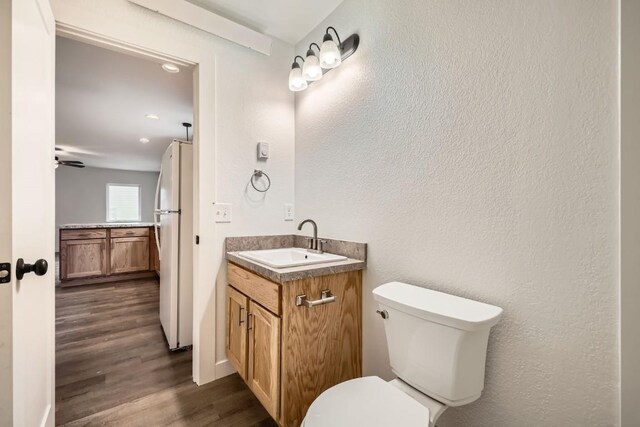 525 Castello Ave, Fairplay, CO 80440 - bathroom featuring toilet, recessed lighting, a ceiling fan, wood finished floors, and vanity