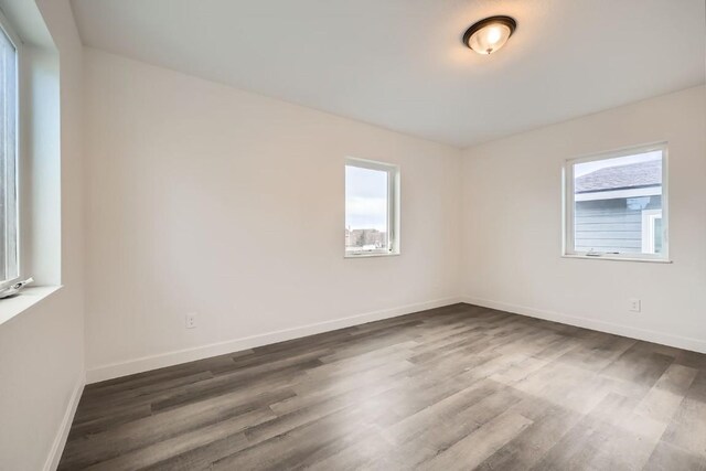 525 Castello Ave, Fairplay, CO 80440 - empty room featuring plenty of natural light, baseboards, and dark wood-style floors