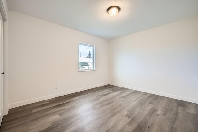 525 Castello Ave, Fairplay, CO 80440 - unfurnished room with baseboards and dark wood-style floors