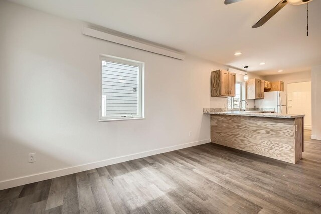 525 Castello Ave, Fairplay, CO 80440 - kitchen featuring a ceiling fan, wood finished floors, baseboards, a peninsula, and freestanding refrigerator
