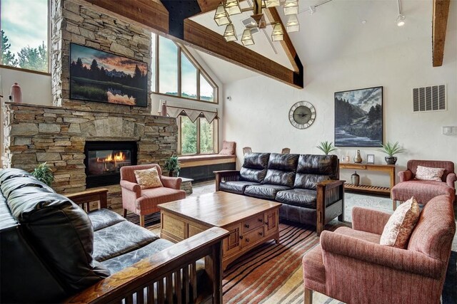 23110 US Highway 6 Unit 5056, Keystone, CO 80435 - living room featuring high vaulted ceiling, a stone fireplace, beam ceiling, and visible vents