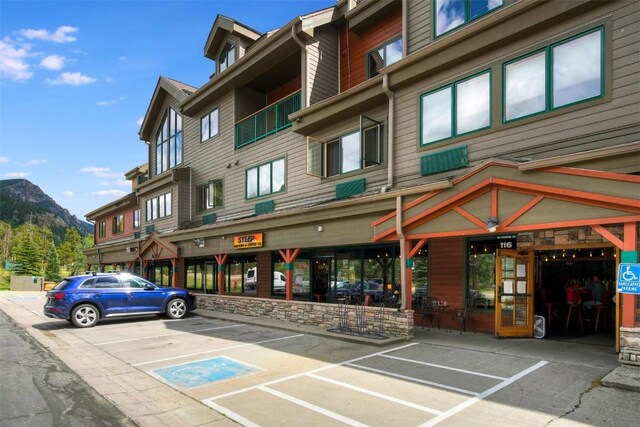 23110 US Highway 6 Unit 5056, Keystone, CO 80435 - view of building exterior with uncovered parking and a mountain view
