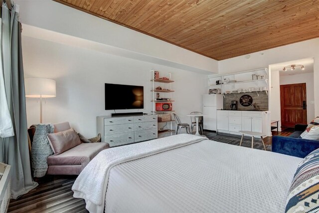 23110 US Highway 6 Unit 5056, Keystone, CO 80435 - bedroom featuring freestanding refrigerator, wooden ceiling, and dark wood-style floors