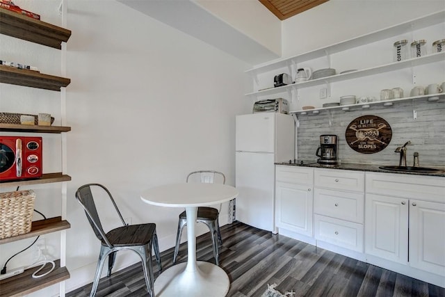 23110 US Highway 6 Unit 5056, Keystone, CO 80435 - interior space with dark wood-style floors, open shelves, a sink, freestanding refrigerator, and white cabinetry