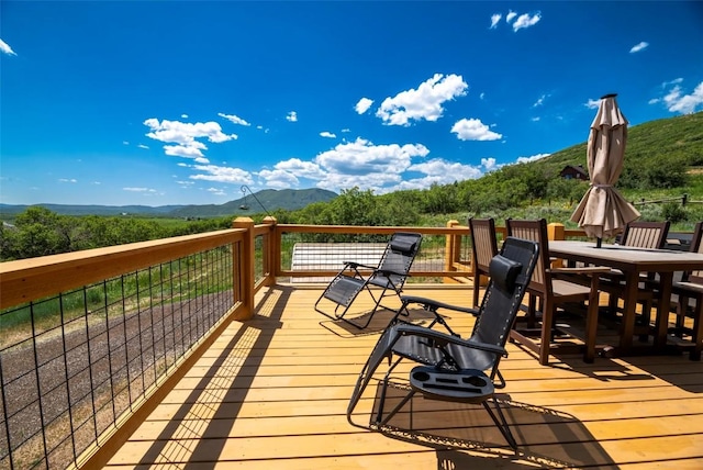 44255 Diamondback Way, Steamboat Springs, CO 80487 - wooden terrace featuring a mountain view and outdoor dining area