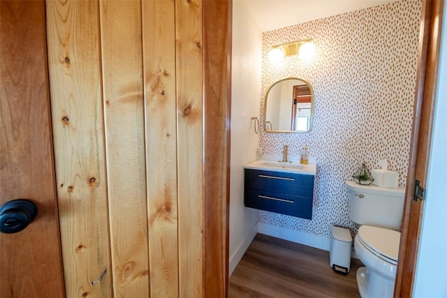 44255 Diamondback Way, Steamboat Springs, CO 80487 - half bath with wallpapered walls, wood finished floors, and vanity
