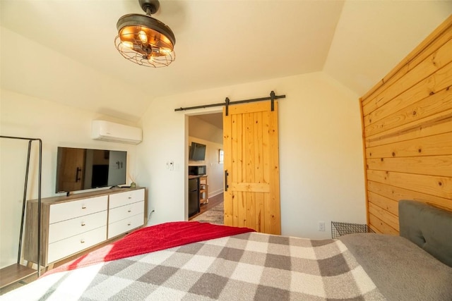 44255 Diamondback Way, Steamboat Springs, CO 80487 - bedroom featuring an AC wall unit, vaulted ceiling, and a barn door
