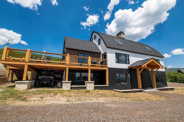 44255 Diamondback Way, Steamboat Springs, CO 80487 - back of house with roof with shingles, a wooden deck, stairway, a chimney, and board and batten siding