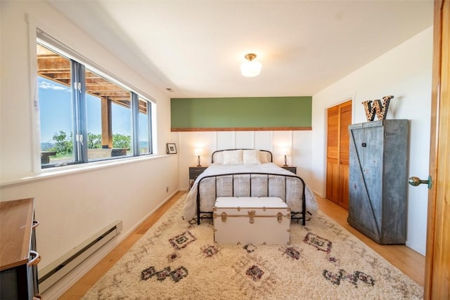 44255 Diamondback Way, Steamboat Springs, CO 80487 - bedroom featuring a baseboard radiator, wood finished floors, and a closet