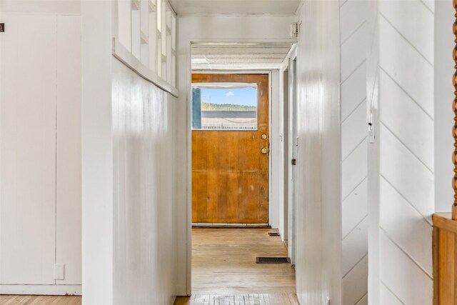 hallway featuring visible vents and wood finished floors