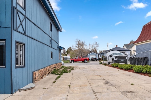 view of street with concrete driveway and a residential view