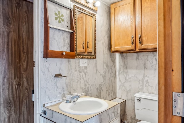 bathroom with toilet and vanity