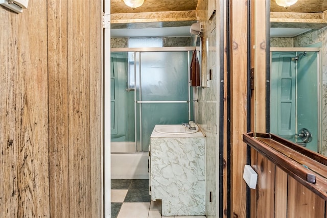 bathroom with vanity and bath / shower combo with glass door