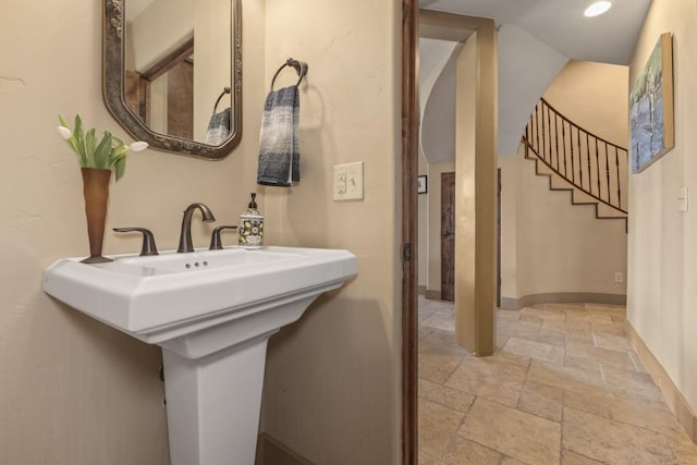 40924 Purple Sage St, Steamboat Springs, CO 80487 - bathroom with stone tile floors, baseboards, a sink, and recessed lighting