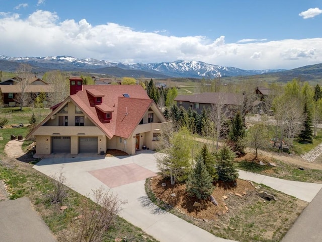 40924 Purple Sage St, Steamboat Springs, CO 80487 - view of front of property with driveway, stucco siding, a garage, and a mountain view