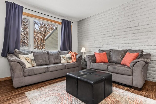 32 Sequoia Court -, Steamboat Springs, CO 80487 - living room featuring baseboards, wood finished floors, and brick wall