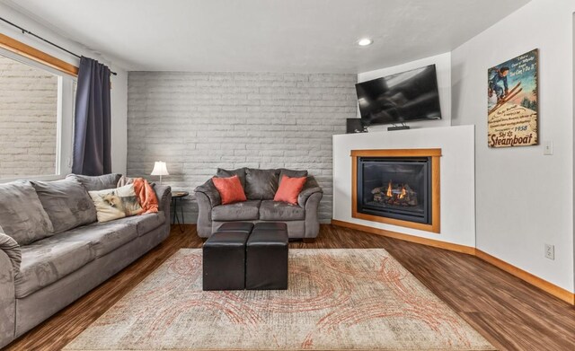 32 Sequoia Court -, Steamboat Springs, CO 80487 - living room featuring recessed lighting, a glass covered fireplace, wood finished floors, and baseboards
