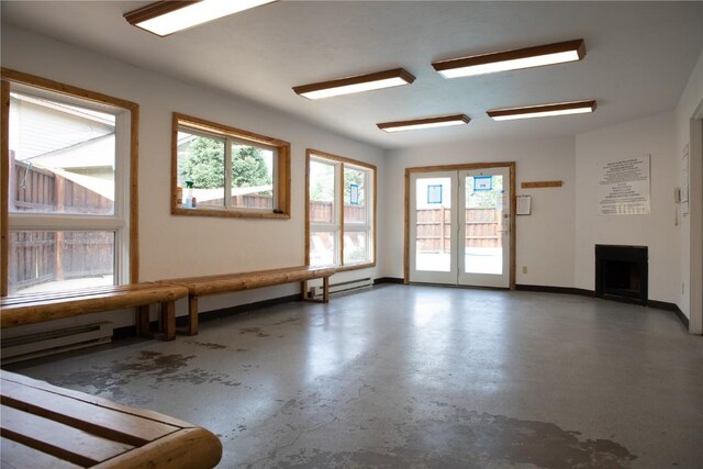 32 Sequoia Court -, Steamboat Springs, CO 80487 - unfurnished living room featuring a baseboard heating unit, a fireplace, baseboards, and concrete floors