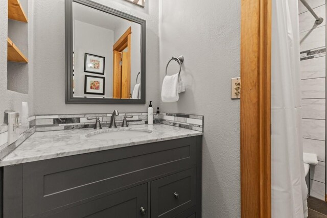 32 Sequoia Court -, Steamboat Springs, CO 80487 - bathroom with a shower with curtain, a textured wall, and vanity