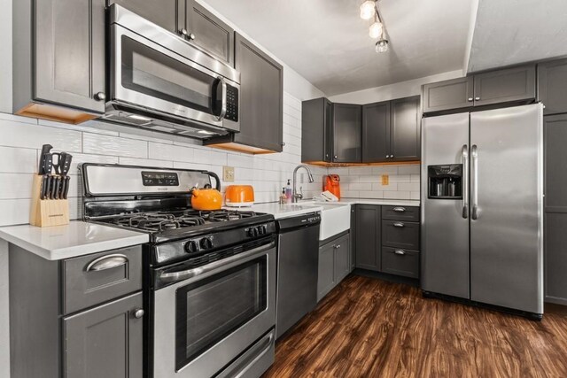 32 Sequoia Court -, Steamboat Springs, CO 80487 - kitchen with dark wood-style floors, a sink, backsplash, light countertops, and appliances with stainless steel finishes