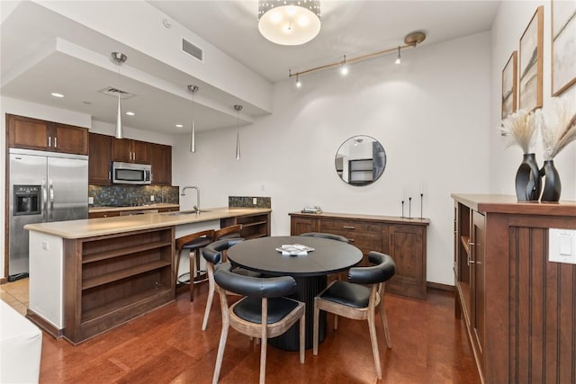 703 Lincoln Ave Unit B206, Steamboat Springs, CO 80487 - dining space featuring rail lighting, wood finished floors, visible vents, and recessed lighting