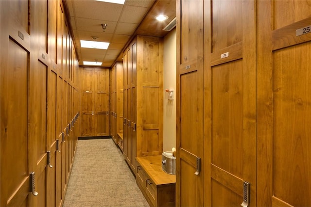 703 Lincoln Ave Unit B206, Steamboat Springs, CO 80487 - hallway with light carpet, a paneled ceiling, and wooden walls