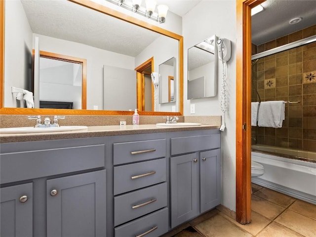 22320 US Highway 6 Unit 1761, Keystone, CO 80435 - full bathroom with double vanity, toilet, shower / bath combination with glass door, tile patterned flooring, and a textured ceiling