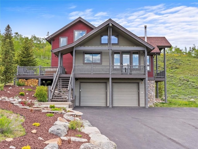 89 Emerald Rd, Silverthorne, CO 80498 - view of front facade featuring driveway, an attached garage, stairway, and stone siding