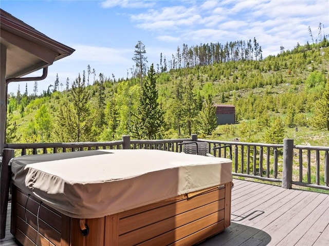 89 Emerald Rd, Silverthorne, CO 80498 - deck featuring a hot tub and a wooded view