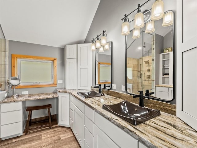89 Emerald Rd, Silverthorne, CO 80498 - bathroom with a shower stall, wood finished floors, double vanity, and vaulted ceiling