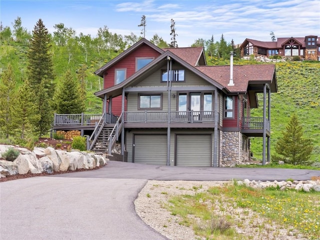 89 Emerald Rd, Silverthorne, CO 80498 - view of front facade with asphalt driveway, an attached garage, and stone siding