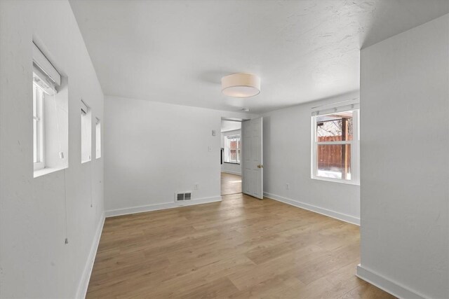 unfurnished room with light wood-type flooring