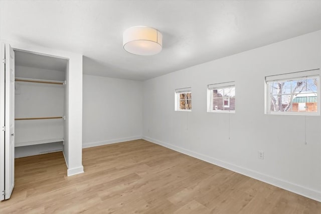 unfurnished bedroom featuring a closet and light hardwood / wood-style flooring