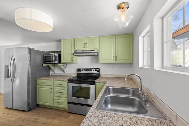 kitchen featuring green cabinets, appliances with stainless steel finishes, and sink