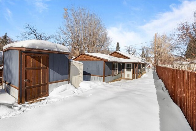 view of snow covered rear of property