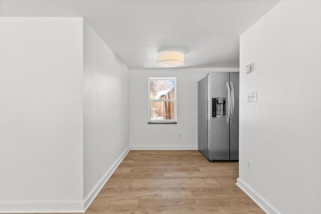 corridor with light wood-type flooring