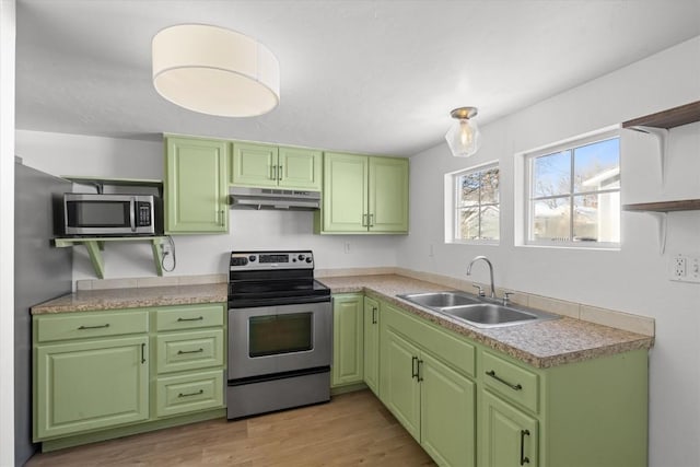 kitchen featuring green cabinets, appliances with stainless steel finishes, light hardwood / wood-style floors, and sink