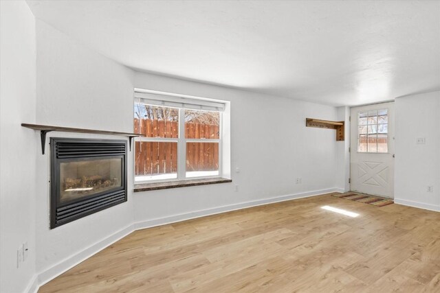 unfurnished living room with light hardwood / wood-style floors